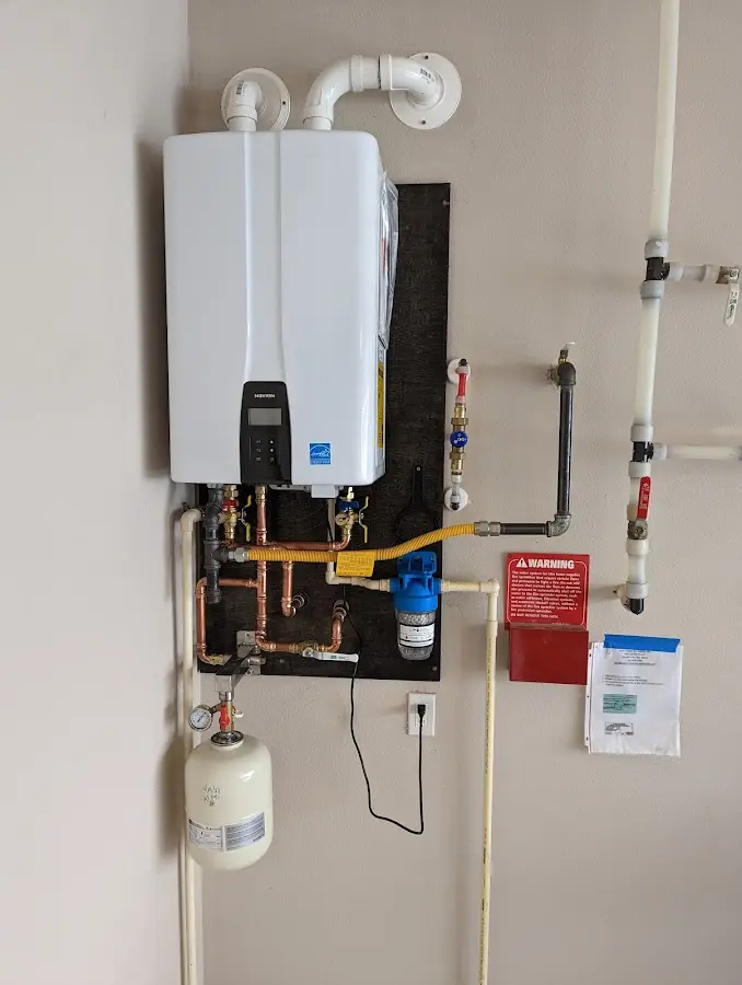 Professional plumber installing copper piping in a Smithville home